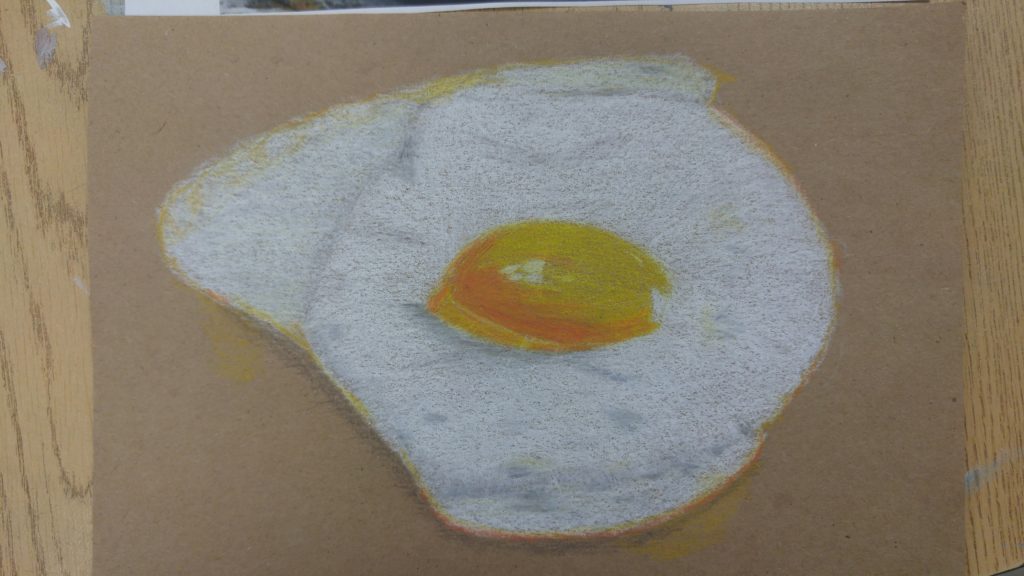 Colored pencil drawing of a sunny-side-up egg drawn on brown paper