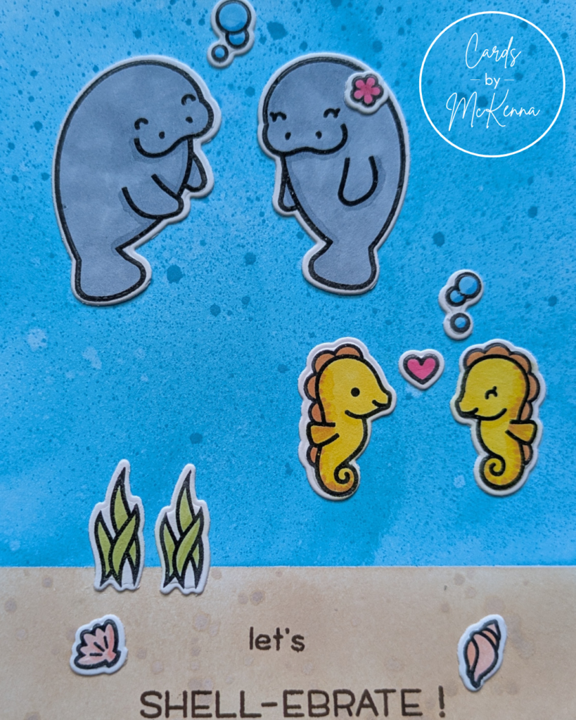 A zoomed-in picture of the handmade card with two manatees and two seahorses in a cute drawing style. The background is a bit blue ocean with a sandy ocean floor. The card reads "Let's Shell-ebrate"